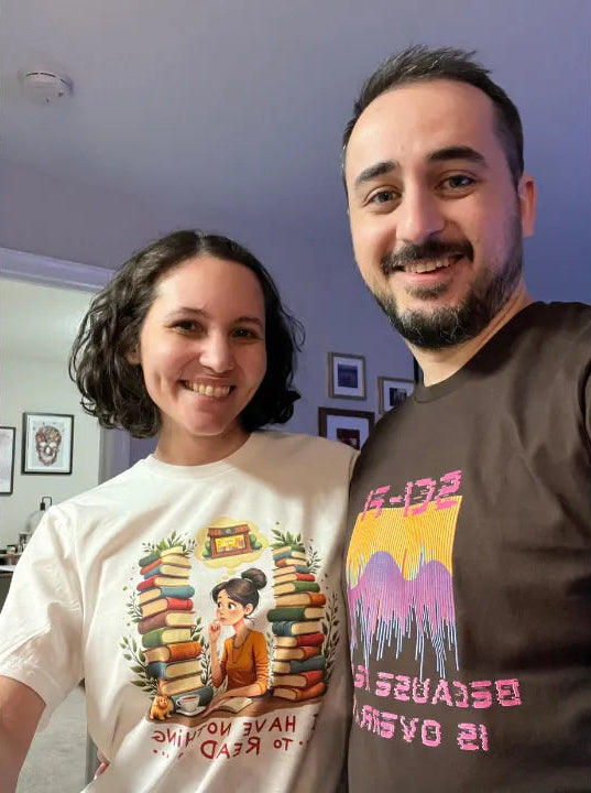We are wearing t-shirts with our bookish graphic designs, one with books and a person, the other with colorful sci-fi design.